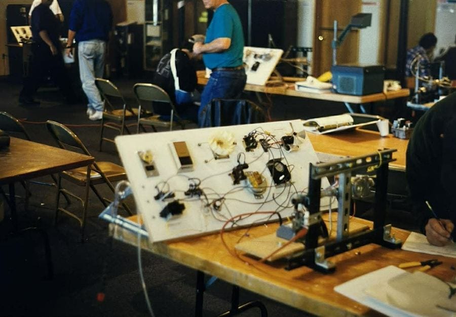 Scanned print from the 1990s showing a tabletop electrical training board in the original Brier shop