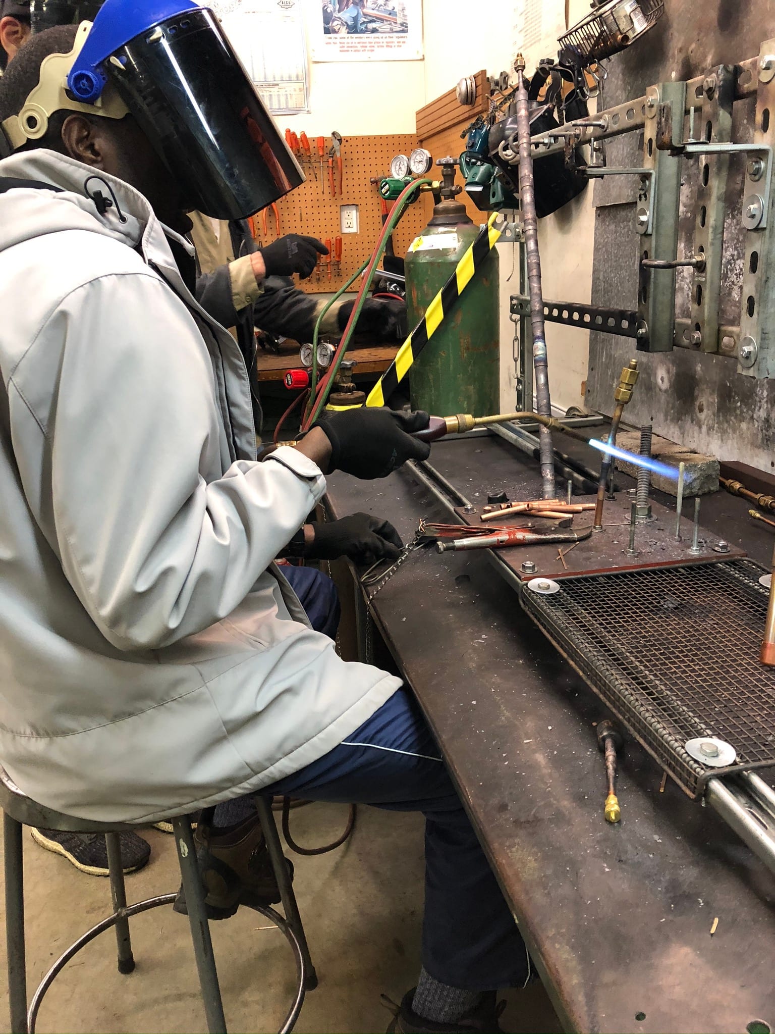 Brazing with torch and PPE at the bench