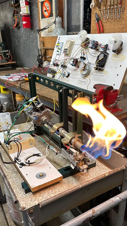 Live burner flame on a training furnace with test equipment