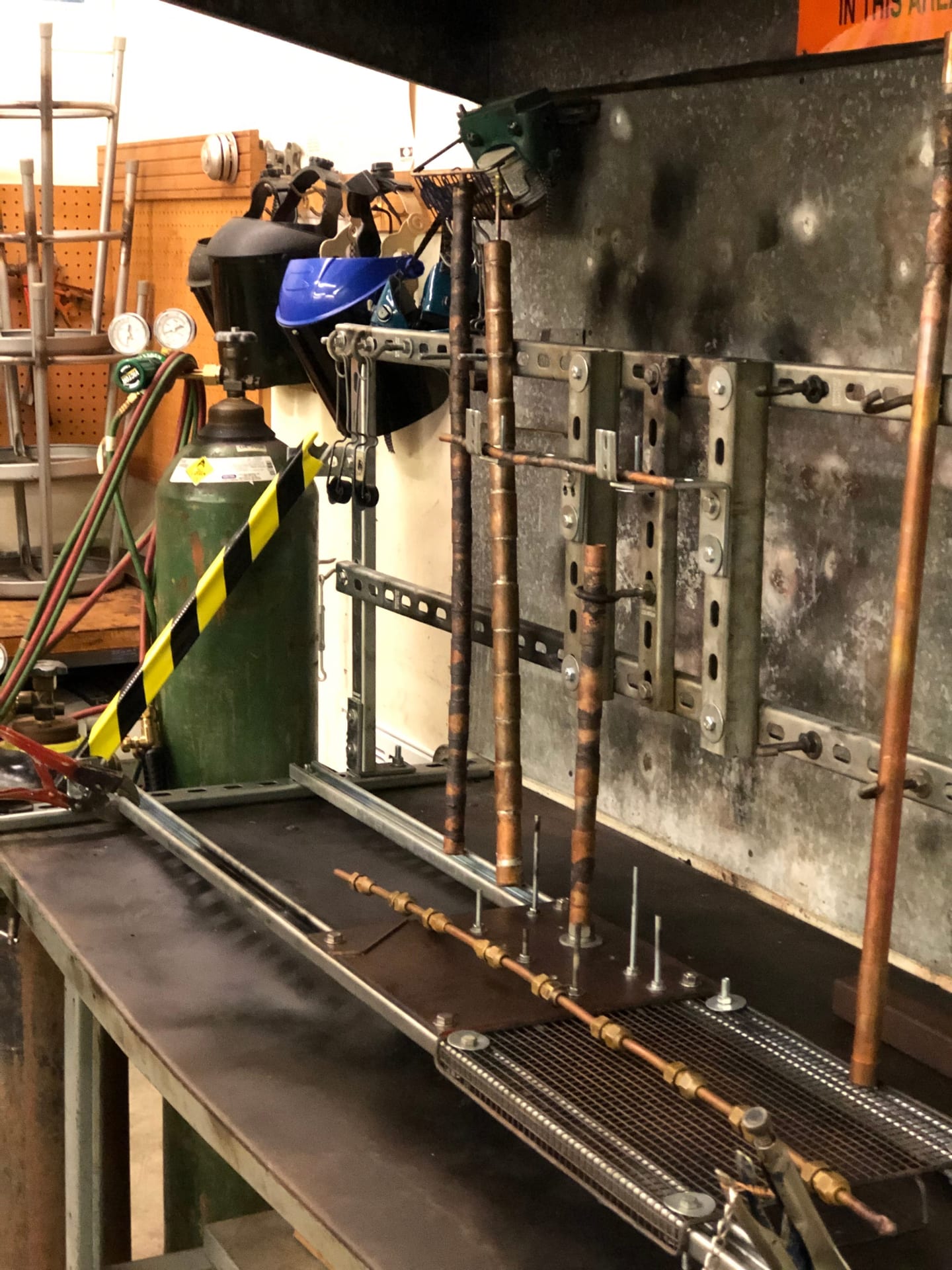 Refrigeration student brazing copper fittings with a torch