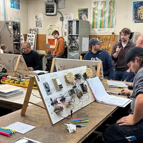 HVAC School class in session with students at training stations