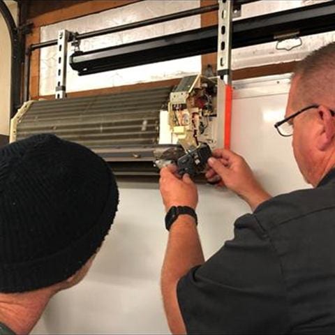 Instructor walking a student through HVAC equipment in the lab